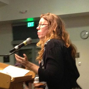 Cali Linfor speaking at a podium